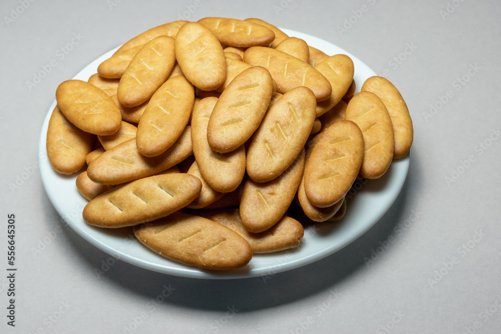 Salty crackers in a Senior Batonio plate on a gray background Salty crackers in a Senior Batonio plate on a gray background