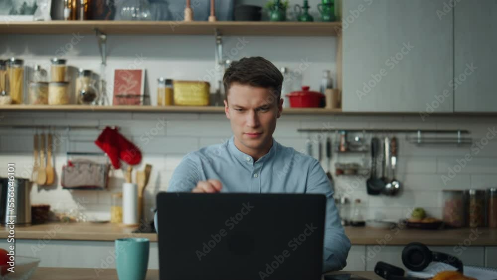 Man finish online meeting closing laptop drinking coffee at kitchen close up. Man finish online meeting closing laptop drinking coffee at kitchen close up.