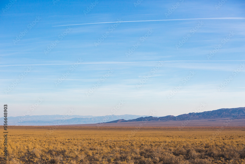 Kazakhstan steppe landscape. Dry grass and mountains Kazakhstan steppe landscape. Dry grass and mountains