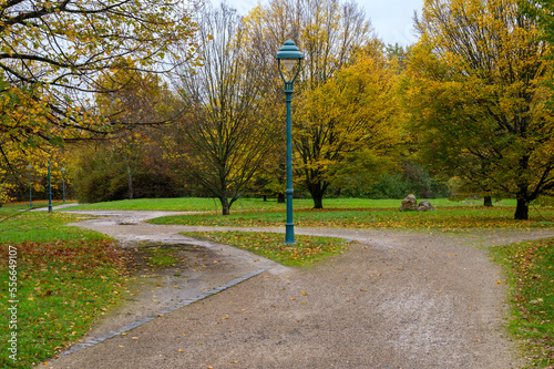 Path in a park around a lamp with a shortcut showing preferred way through