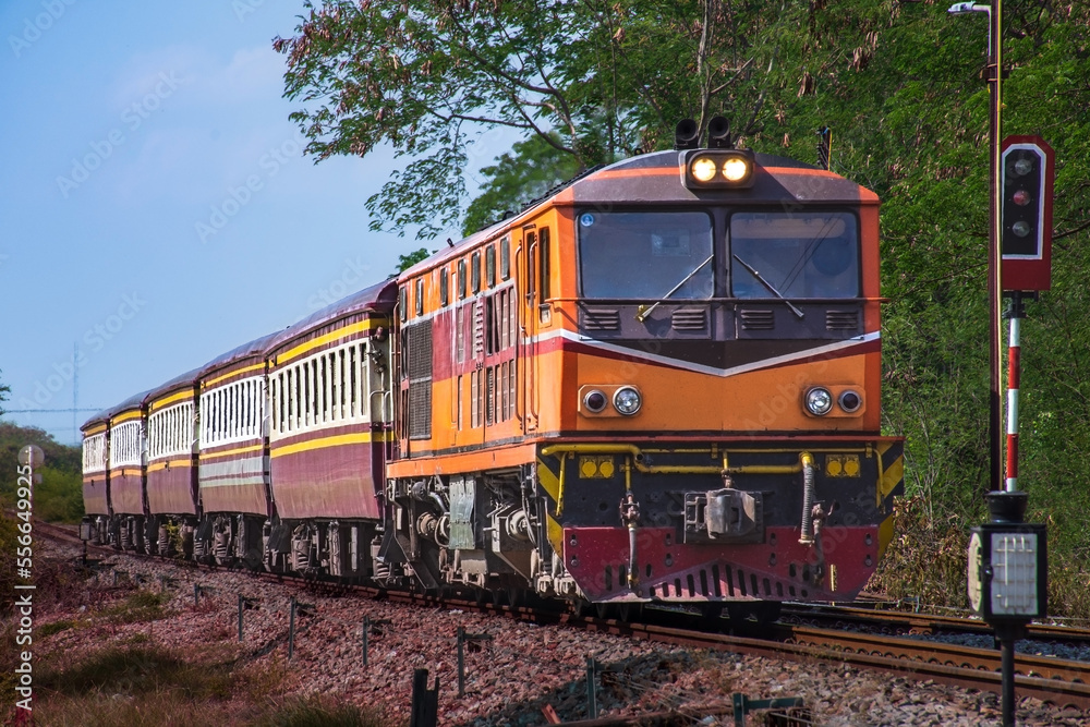 Fototapeta premium Passenger train by diesel locomotive on the railway.