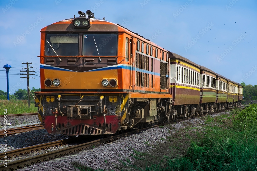 Passenger train by diesel locomotive on the railway.