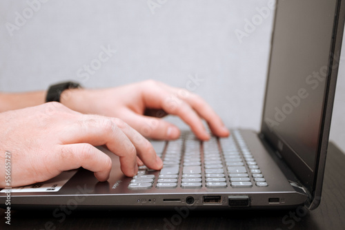 Man is typing on a laptop