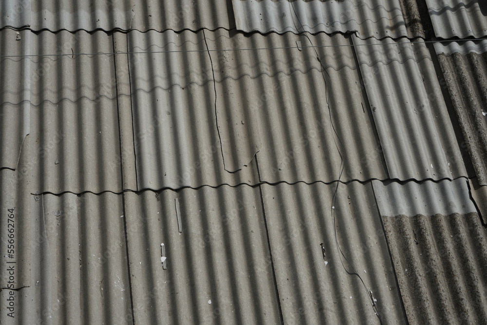 Closeup of a slated roof (as a background or texture). The roof is covered with old slate. Closeup of a slated roof (as a background or texture). The roof is covered with old slate.
