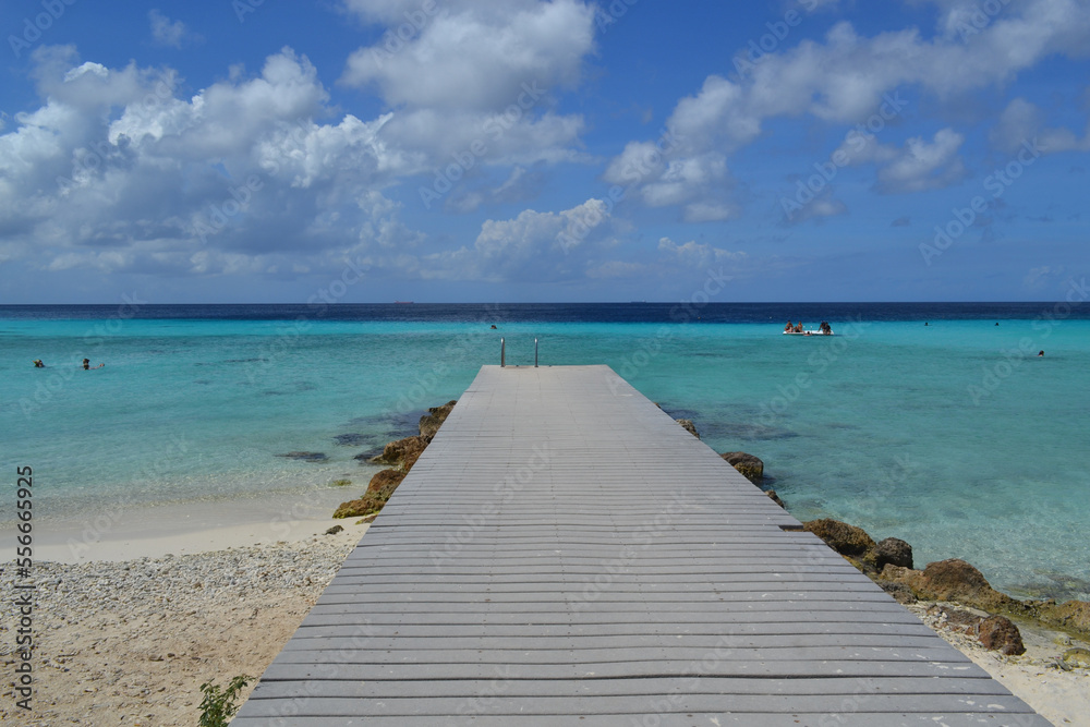 a beautiful wooden pier on a paradise beach on the island of Curacao in the caribbean sea