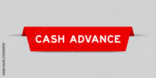 Red color inserted label with word cash advance on gray background