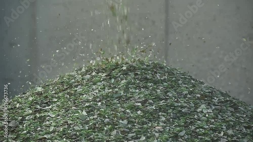 Crushed small pieces of glass are gathered for recycling in a machine in a recycling facility. Glass waste management. Glass recycling photo
