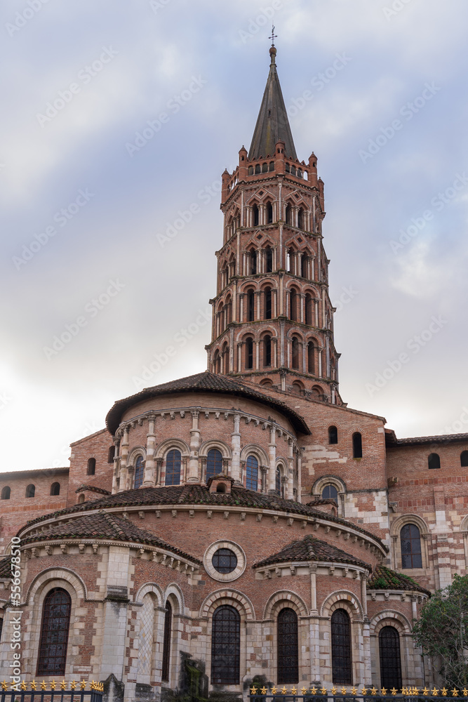 Vertical landscape view of the apse and bell tower of ancient landmark St Sernin basilica, Toulouse, France