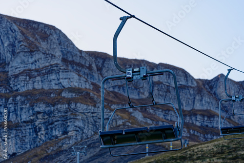 Empty seat of chair lift in the Swiss Alps at Axalp, Canton Bern, on a sunny autumn morning. Photo taken October 18th, 2022, Axalp, Switzerland. photo