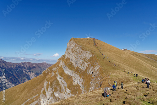 Spectators of 2022 Air Display Axalp of Swiss Air Force on the steep way up in the Swiss Alps to the spectators areas on a sunny autumn morning. Photo taken October 18th, 2022, Axalp, Switzerland. photo