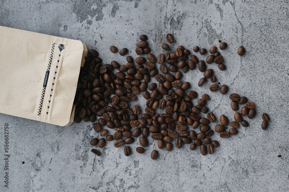 Roasted coffee beans and eco packaging isolated on gray background. Roasted coffee beans and eco packaging isolated on gray background.
