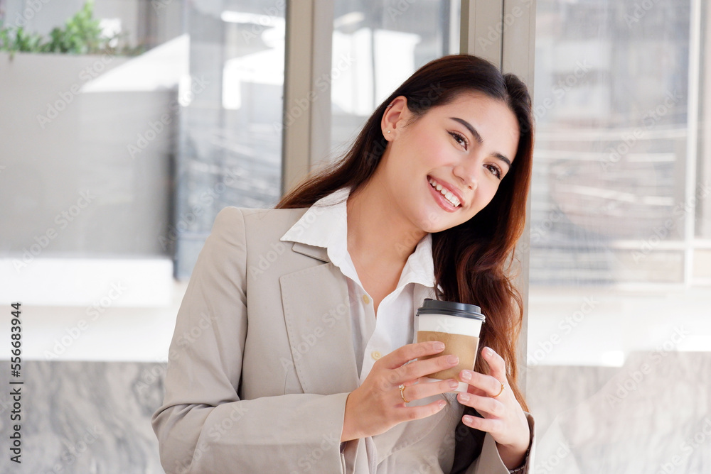 Young beautiful business woman drinking hot coffee in the morning.