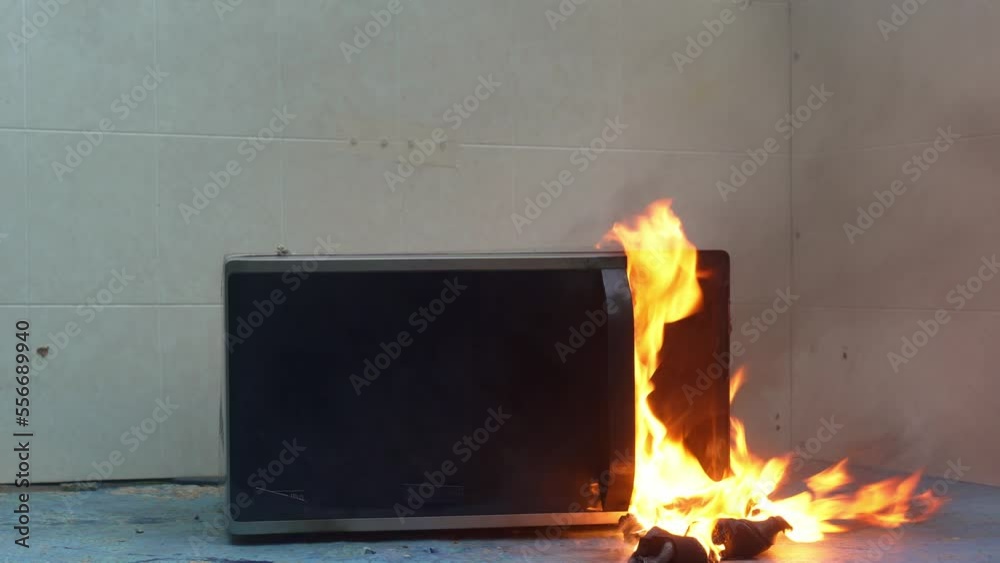 microwave oven on fire. the concept of fire in the kitchen and