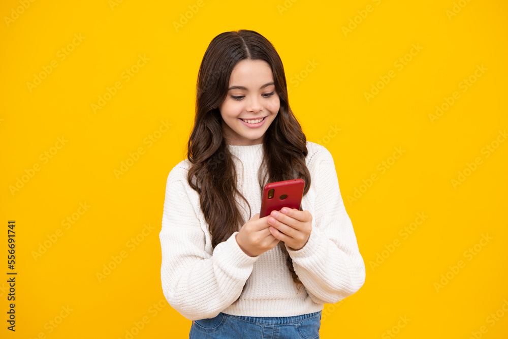 Portrait of cute teenage girl using mobile phone, chatting on web, typing sms message. Mobile app for smartphone. Children lifestyle concept. Mock up copy space. Happy face. Portrait of cute teenage girl using mobile phone, chatting on web, typing sms message. Mobile app for smartphone. Children lifestyle concept. Mock up copy space. Happy face.