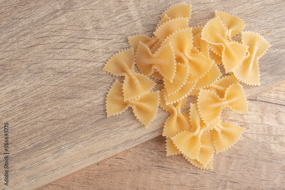 Raw macaroni on wooden background