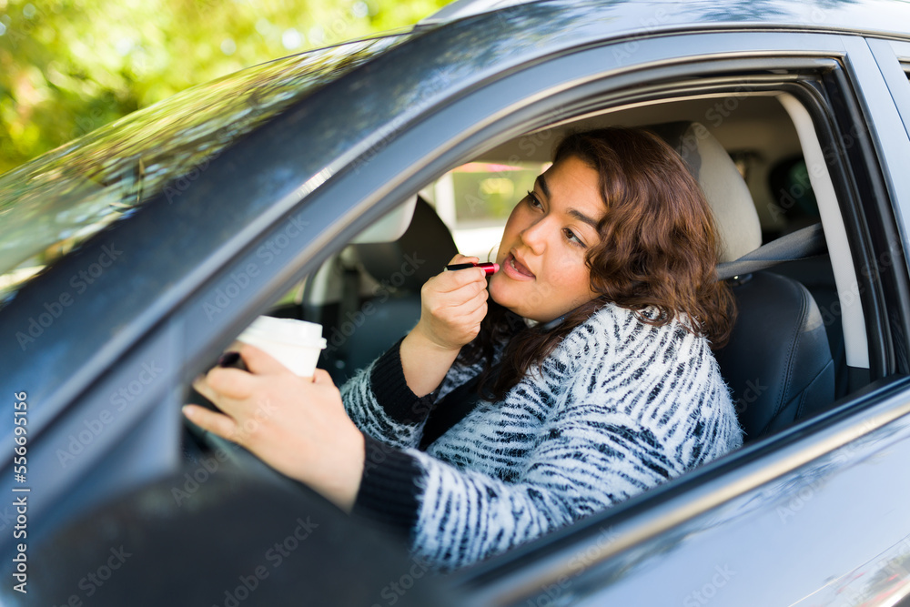 Busy fat woman driving while putting on makeup