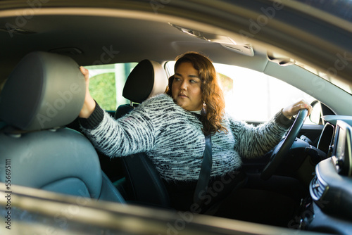 Beautiful fat woman driving in reverse photo