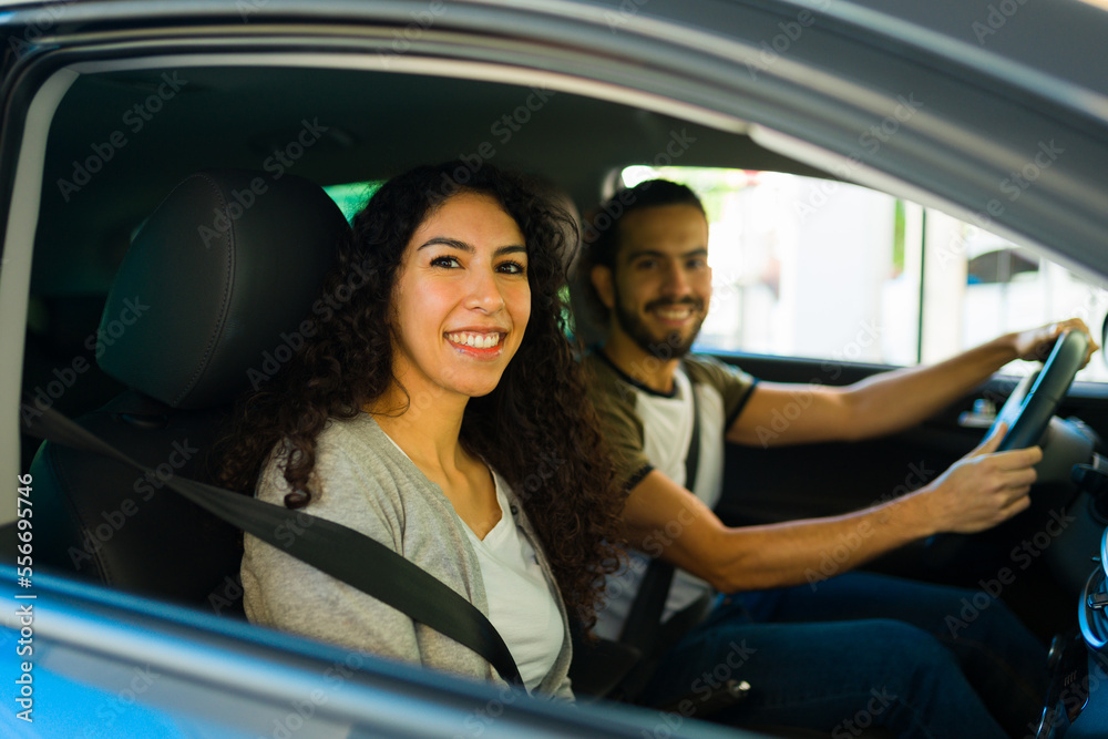 Cheerful couple smiling driving together in the car Cheerful couple smiling driving together in the car