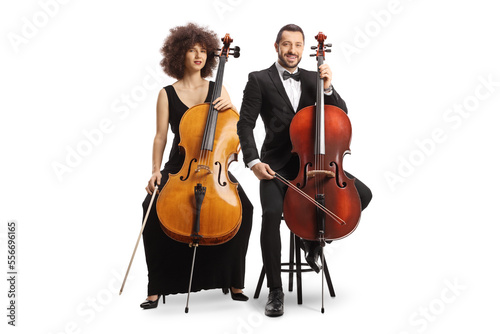 Elegant male and female musicians sitting on chairs with cellos