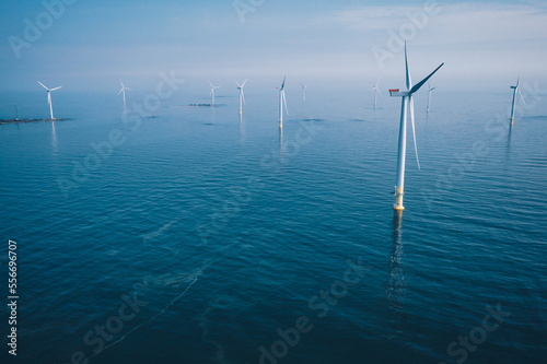 Obraz na płótnie Wind turbine. Aerial view of wind turbines or windmills farm field in blue sea in Finland. w salonie