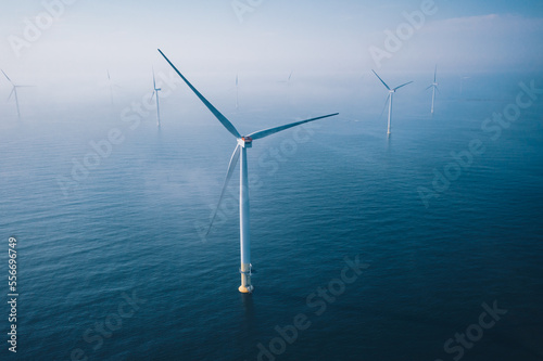 Wind turbine. Aerial view of wind turbines or windmills farm field in blue sea in Finland.