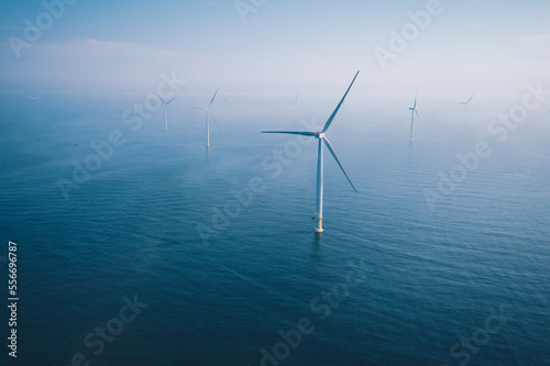 Wind turbine. Aerial view of wind turbines or windmills farm field in blue sea in Finland. photo