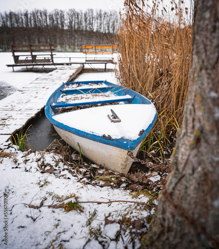 Pier at the frozen lake wit...