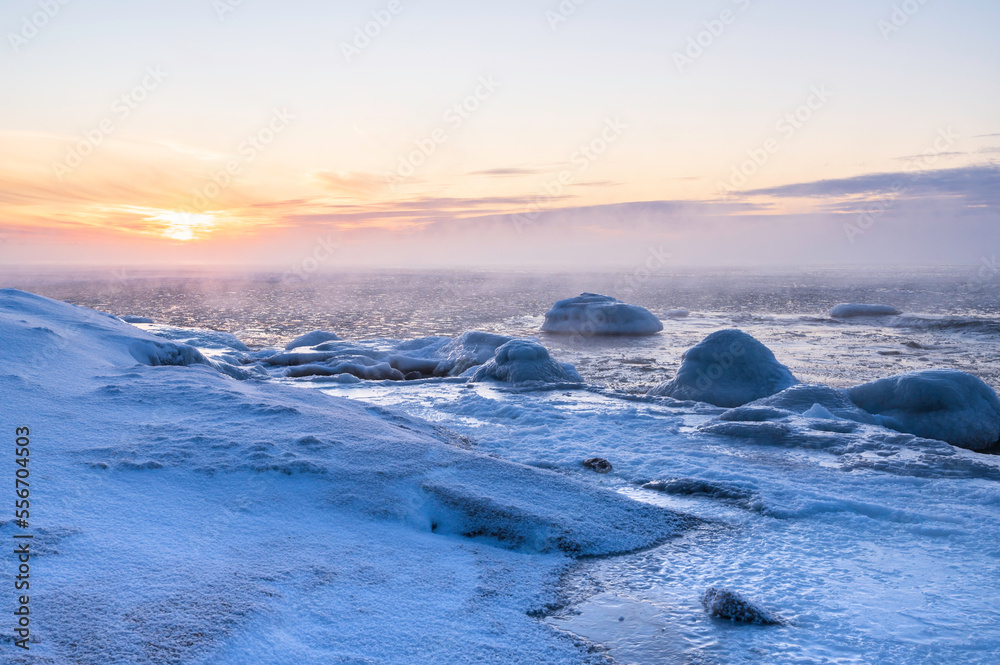 View of the frozen beach and sunset over the sea. Pörkenäs, Jakobstad/Pietarsaari. Finland