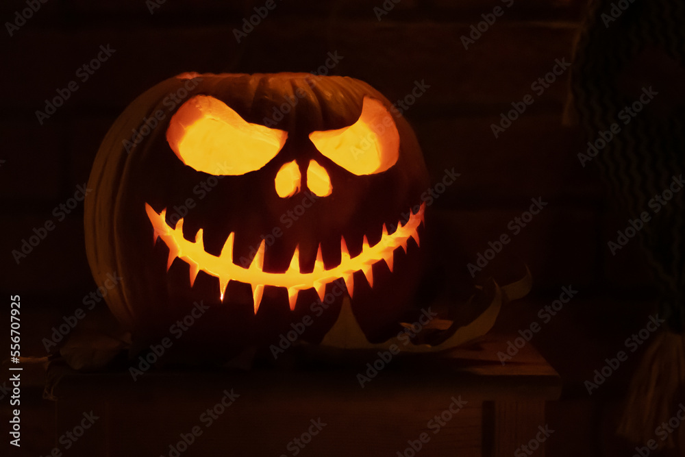 Spooky Halloween pumpkin, Jack O Lantern with Jack Skeletron from the movie  The Nightmare Before Christmas, with pumpkins lights hanging from a window  during a party Stock Photo