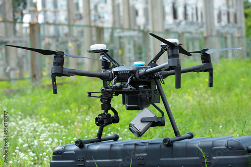 Pro Industrial drone placed on a box before launching for testing power transmission lines of an electrical substation