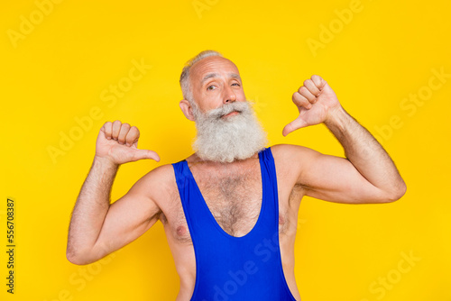 Portrait of confident arrogant aged man direct thumb fingers self isolated on yellow color background