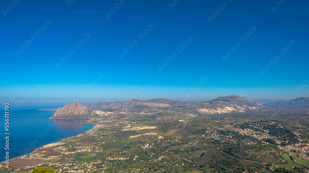 Panorama of the west coast of Sicily with inland view and seaside, the Gulf of Bonagia on the Tyrrhenian Sea stretched from Erice to Monte Cofano. Inland the marble quarries and the town of Valderice