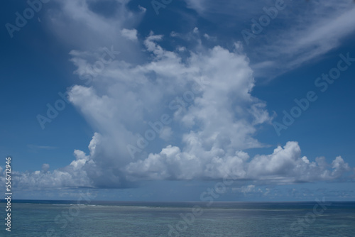 White cumulus clouds in blue sky over sea landscape, big cloud above ocean water panorama, horizont