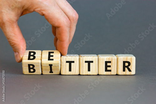 Better or bitter symbol. Concept word Better and Bitter on wooden cubes. Businessman hand. Beautiful grey table grey background. Business and better or bitter concept. Copy space. photo