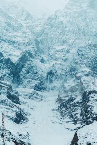 Frozen waterfall on the Himalayan mountains during the winter season at Lahaul in Himachal Pradesh, India. Snow covered mountains during the winter. Natural winter background of the Himalayas. 