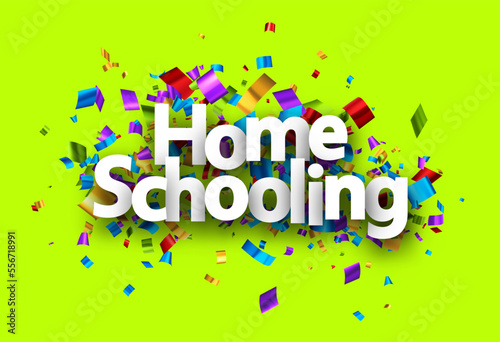 Home schooling sign over colorful cut out foil ribbon confetti background.