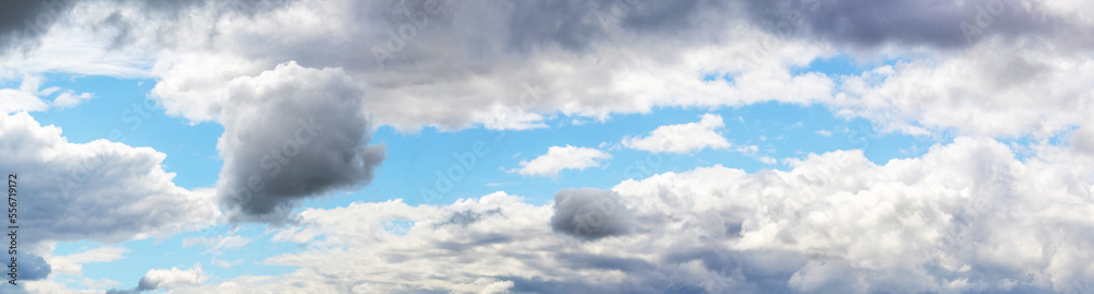 Blue sky with various white and gray clouds in sunny weather