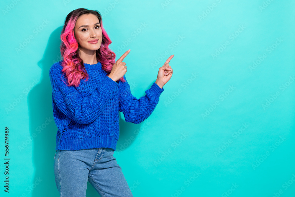 Portrait of nice bright woman with wavy hairstyle wear knit pullover indicating empty space isolated on vivid teal color background Portrait of nice bright woman with wavy hairstyle wear knit pullover indicating empty space isolated on vivid teal color background