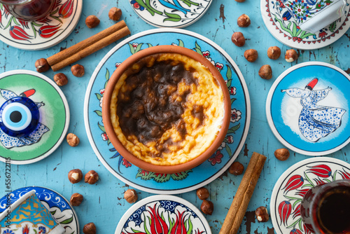 Photograph of Rice Pudding (Turkish Sutlac) in Ottoman Tile Turkish Coffee Cup and Turkish Tea Concept, Uskudar Istanbul, Turkey photo