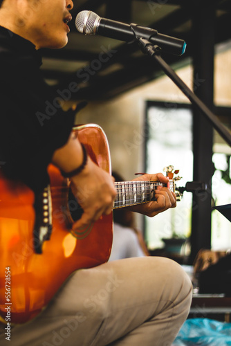 Musicians who play guitar and sing along in the restaurant sit and chill.