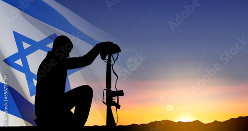 Silhouette of soldier kneeling down on a background of sunset and Israel flag. Greetning card for National Holidyas. EPS10 vector