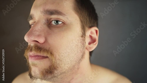 face shaving electric razor. cut facial stubble by shaver. stubble man beard shaving process. unshaven guy. beard trim. man shaving face close up. man cutting his beard. dry shaving electric shaver. photo
