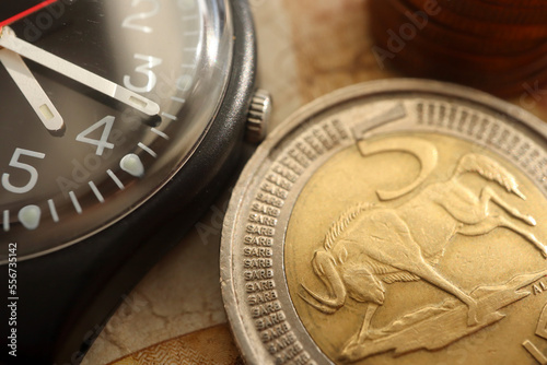 time is money concept. South African currency and a watch photo