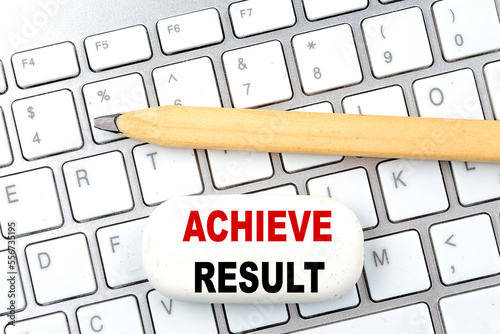 ACHIEVE RESULTS text on eraser with pencil on keyboard