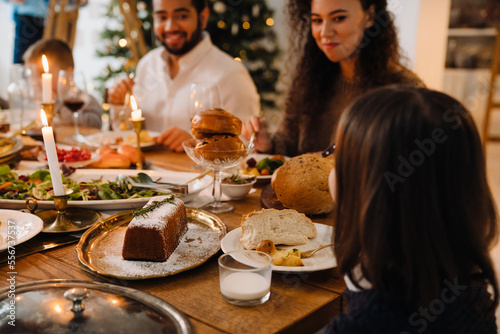 Joyful family eating delicious food during traditional Christmas dinner