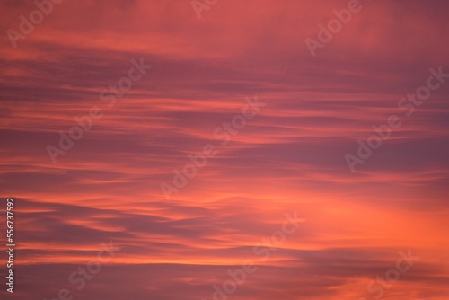 Beautiful evening sky with orange, grey, yellow clouds after the sunset, like an abstract painting