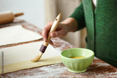 Woman Brushing Egg onto Pastry