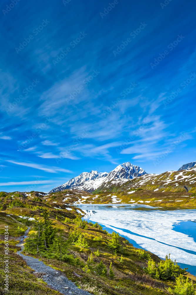 Resurrection Peaks and half frozen Lost Lake, Chugach National Forest, Kenai Peninsula, South-central Alaska in springtime; Seward, Alaska, United States of America Resurrection Peaks and half frozen Lost Lake, Chugach National Forest, Kenai Peninsula, South-central Alaska in springtime; Seward, Alaska, United States of America