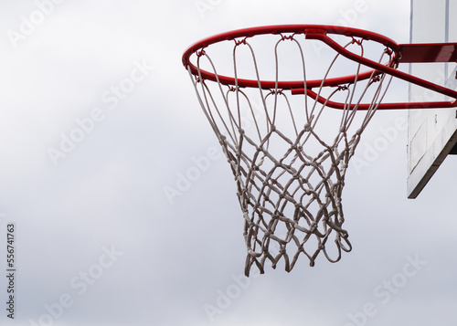 basketball hoop against blue sky © niklas storm