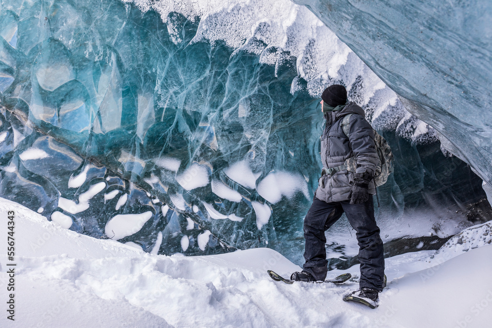 Fort Greely soldier observing the ice inside a cave on Canwell Glacier